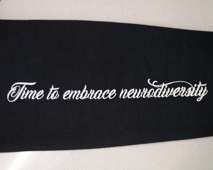 Black ribbon with white text 'Time to embrace neurodiversity' on a white background